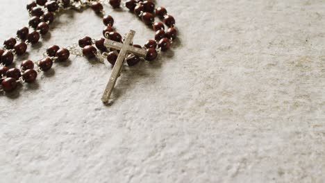 close up of rosary on white background with copy space