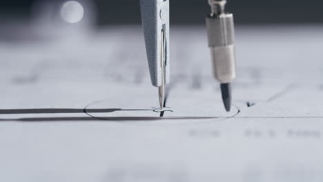 close-up of a drafting compass drawing on architectural paper