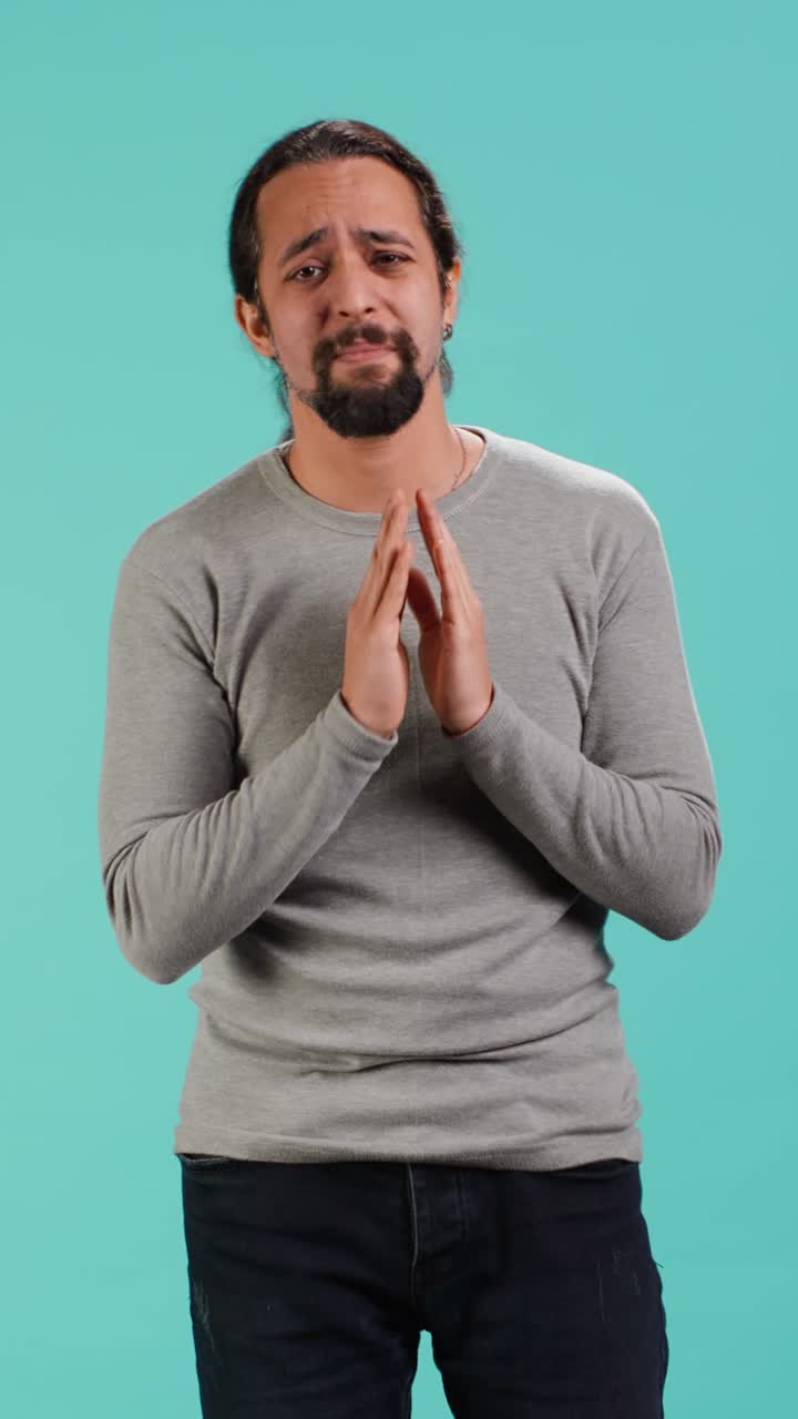 Vertical video Man putting hands together in begging gesture, asking for favor