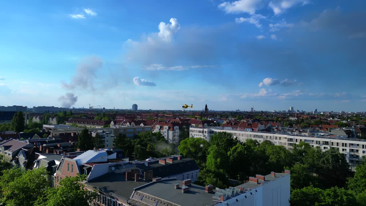 Yellow rescue helicopter landing in a Berlin urban park during a dust emergency. Great aerial view flight drone panorama overview drone