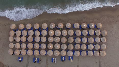 sunbeds at the beach with few people relaxing there aerial view