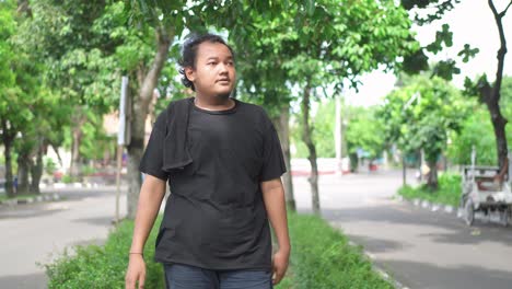 man walking outdoors on a hot day