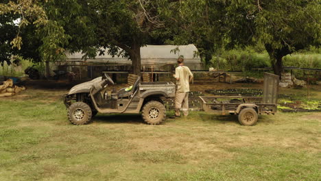 young-farmhand-worker-loading-the-back-of-the-truck-with-organic-plants