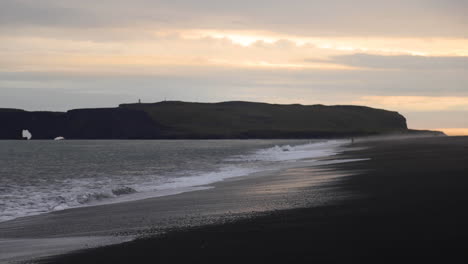 gorgeous wide shot of waves crashing on shore at the reynisfjara black sand beach, iceland