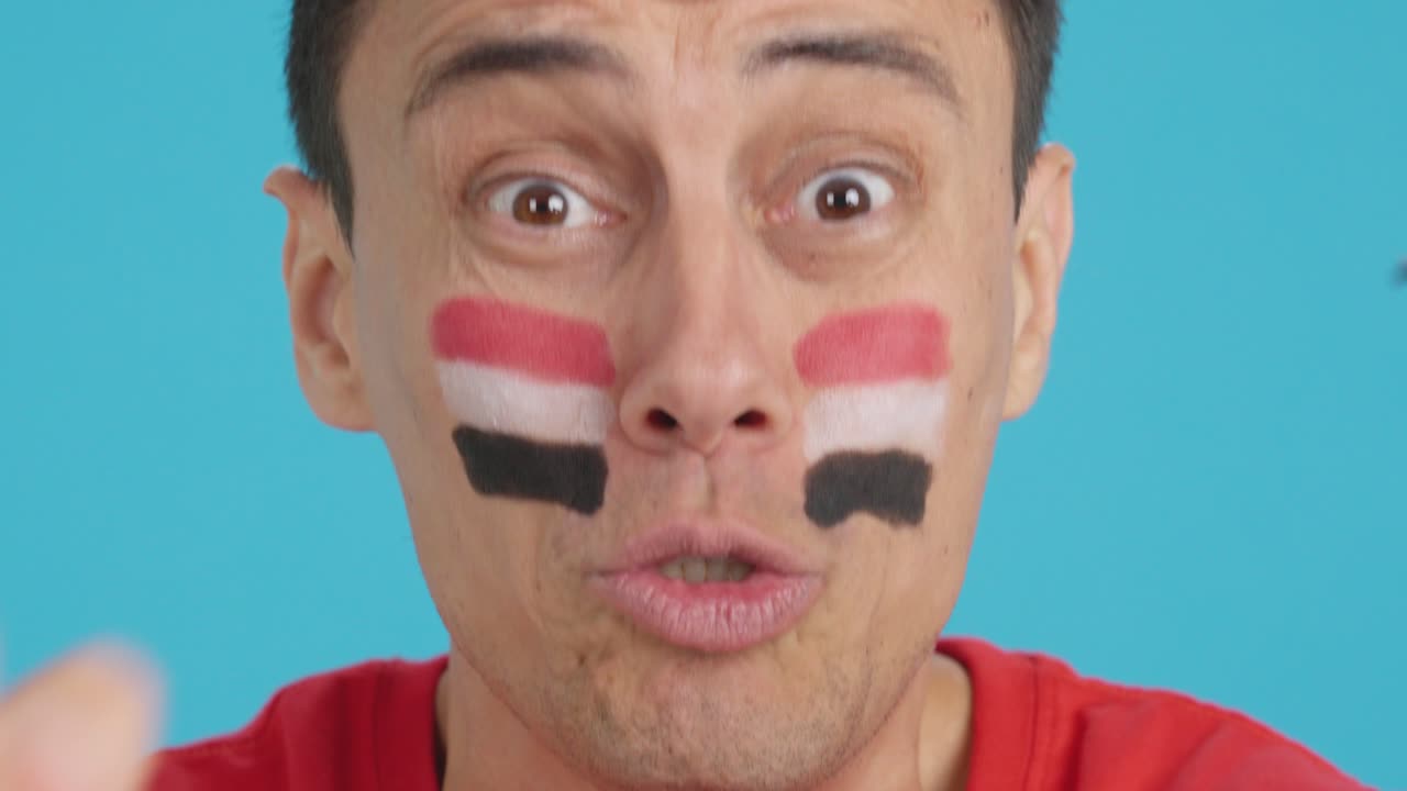 Close up of a man supporting egyptian team