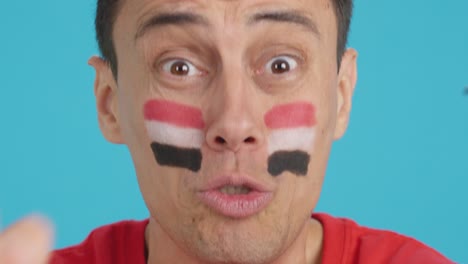 close up of a man supporting egyptian team