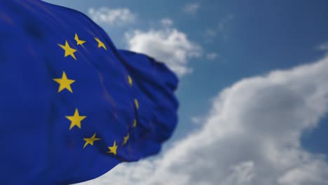 waving european union flag in cloudy sky.