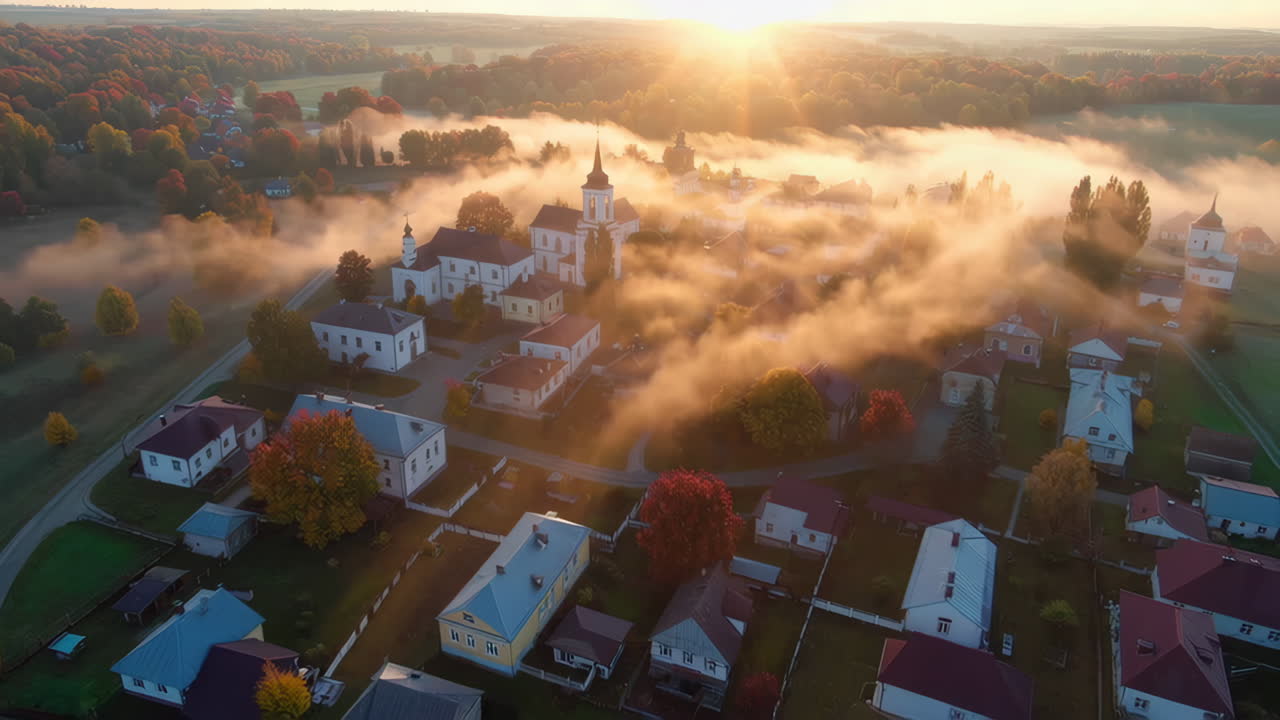 Aerial View of a European Village Covered in Morning Mist During Sunrise