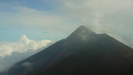 lush volcano mountain with misty clouds surrounding