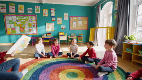 preschool teacher reading story to students