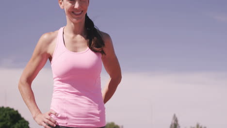 smiling sportswoman stretching