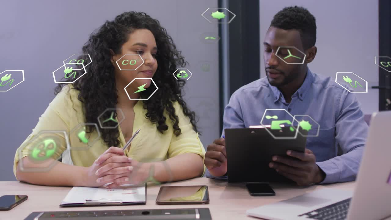 Woman reaching stylus toward tablet, starting green hex AR while man tapping, reviewing tech data