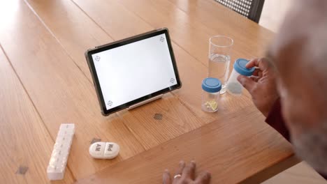 close up of senior biracial man using tablet with copy space on screen, slow motion