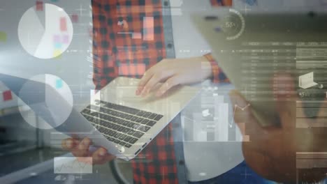 A-group-of-executives-using-a-laptop-and-digital-tablet-in-their-office