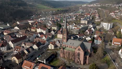 aerial view of a european town with a prominent church and spire