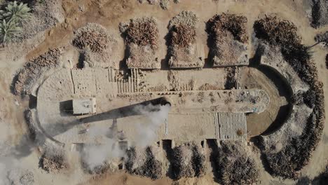 aerial shot of burning of stubble at a farm in khairpur sindh with dates palm tree lying in the floor