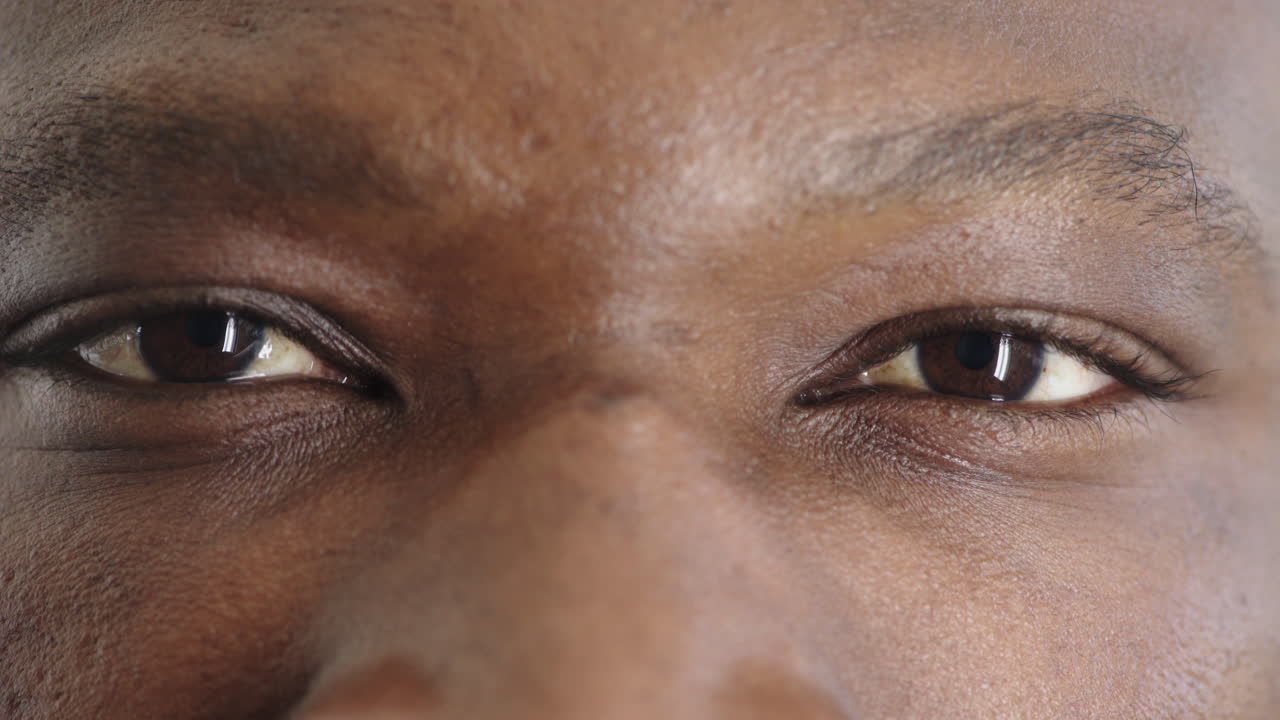 close up african american man eyes opening looking at camera iris reflection healthy eyesight