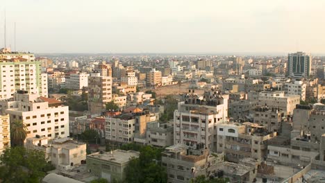 wide shot of gaza, densely populated area with spires from a mosque in the background