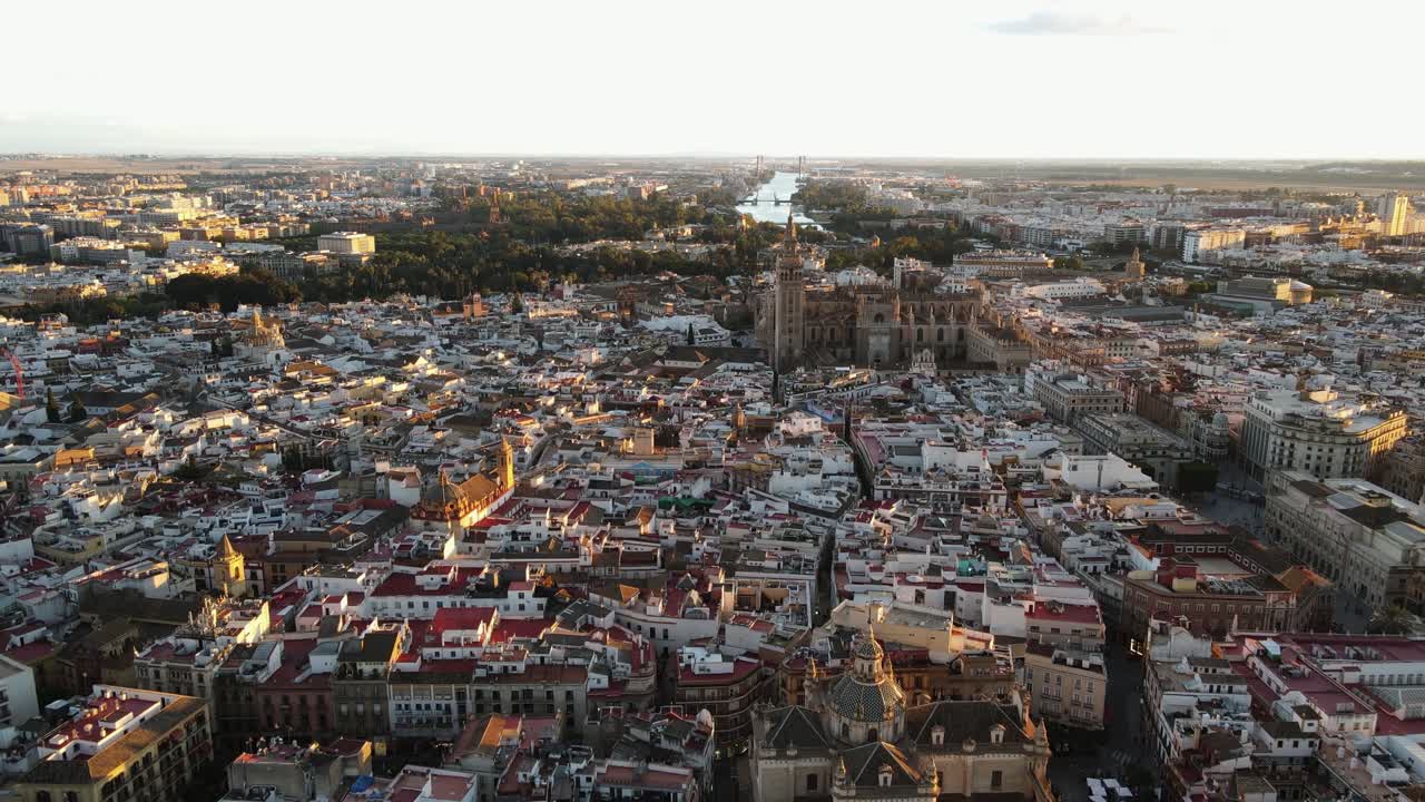 Aerial drone shot of Seville, the capital city of Spain's Andalusia region. Seville is known for its culture, heritage, and being the birthplace of Flamenco. Also seen is the bell tower “La Giralda”