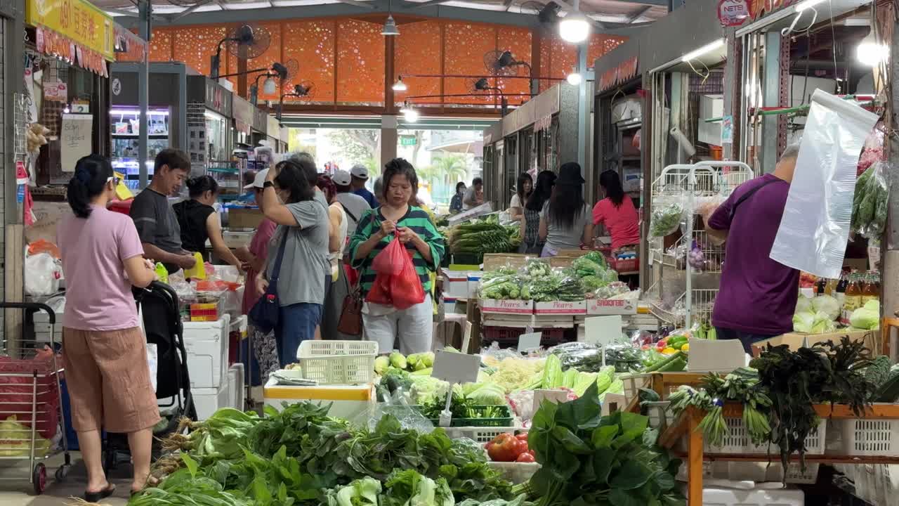Locals shop for their daily groceries in Whampoa Wet Market, Singapore.