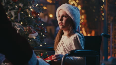 girl in wheelchair receives christmas gift