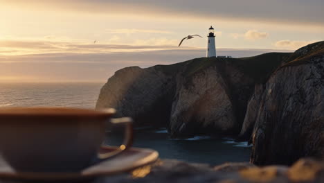 scenic lighthouse view with a warm drink at sunrise or sunset
