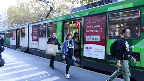 people boarding and exiting a tram