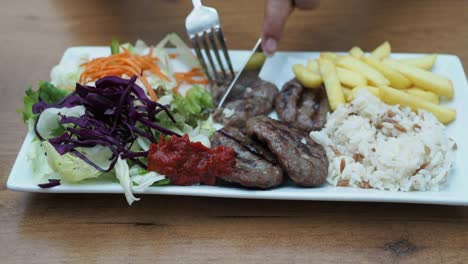 person eating a turkish kofta meal