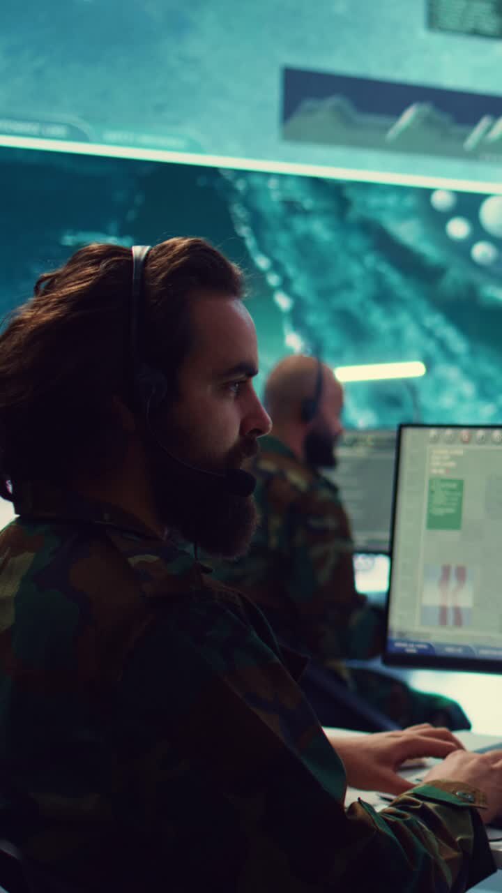Focused Man in Headset Working on Computer in Control Room