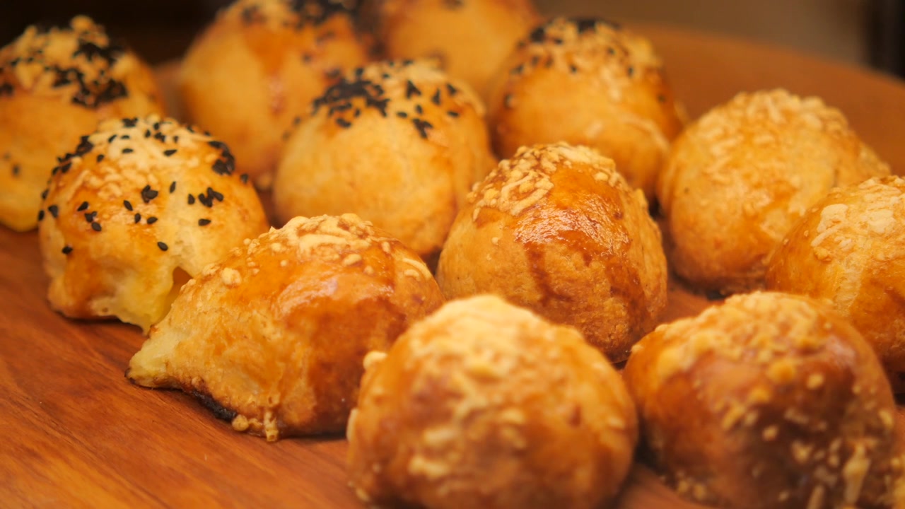 Freshly Baked Savory Pastries on a Wooden Board