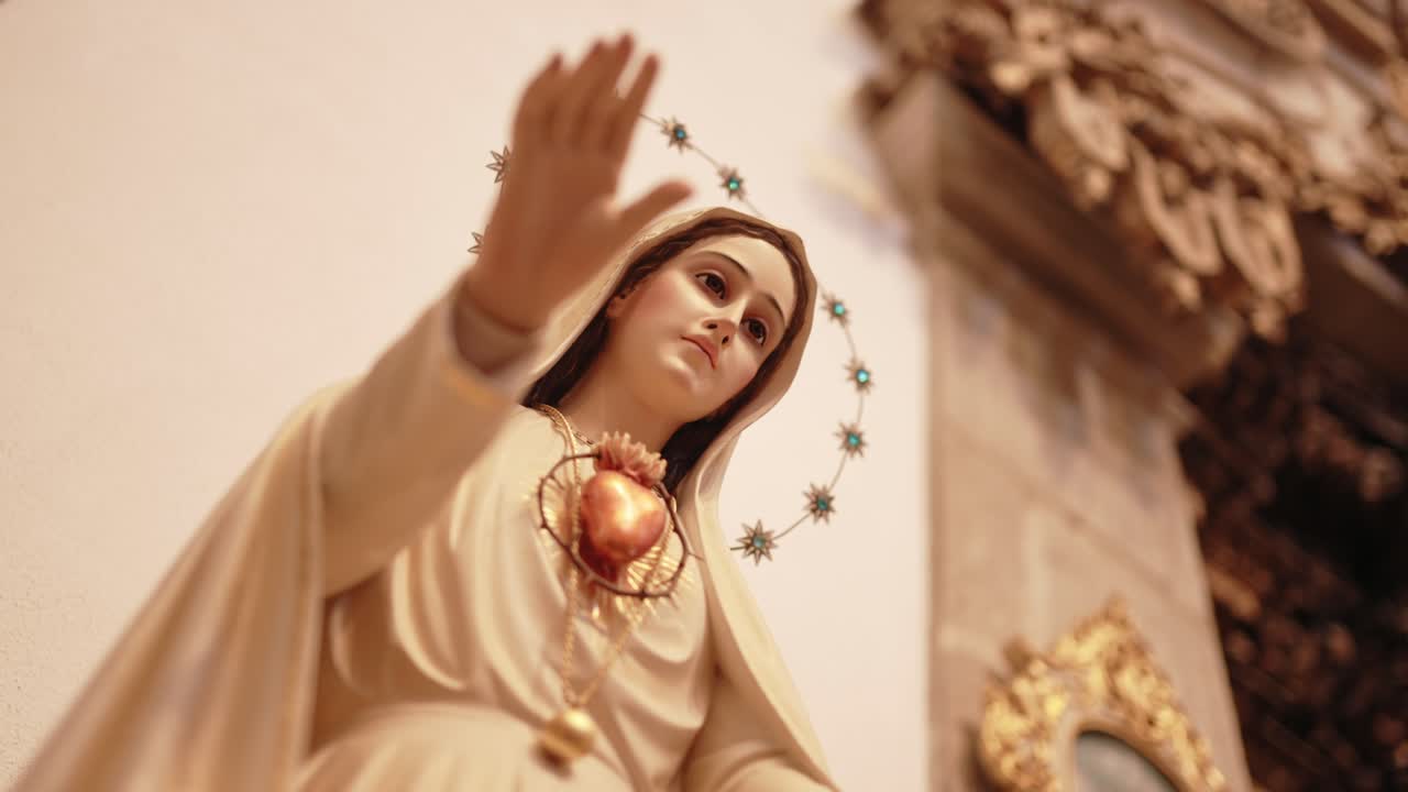 Sacred Heart Virgin Mary statue with raised blessing hand in church
