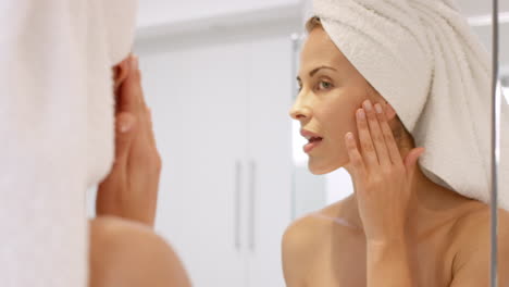 beautiful-woman-applying-skincare-lotion-to-face-caring-for-skin-with-feminine-beauty-products