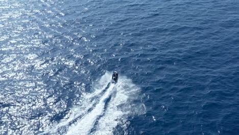 Ariel-drone-footage-of-man-riding-jet-ski-off-the-coast-of-Malta-in-the-Mediterranean-Sea-on-vacation