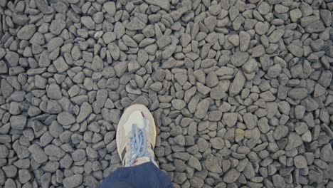 man walking on black and white stones