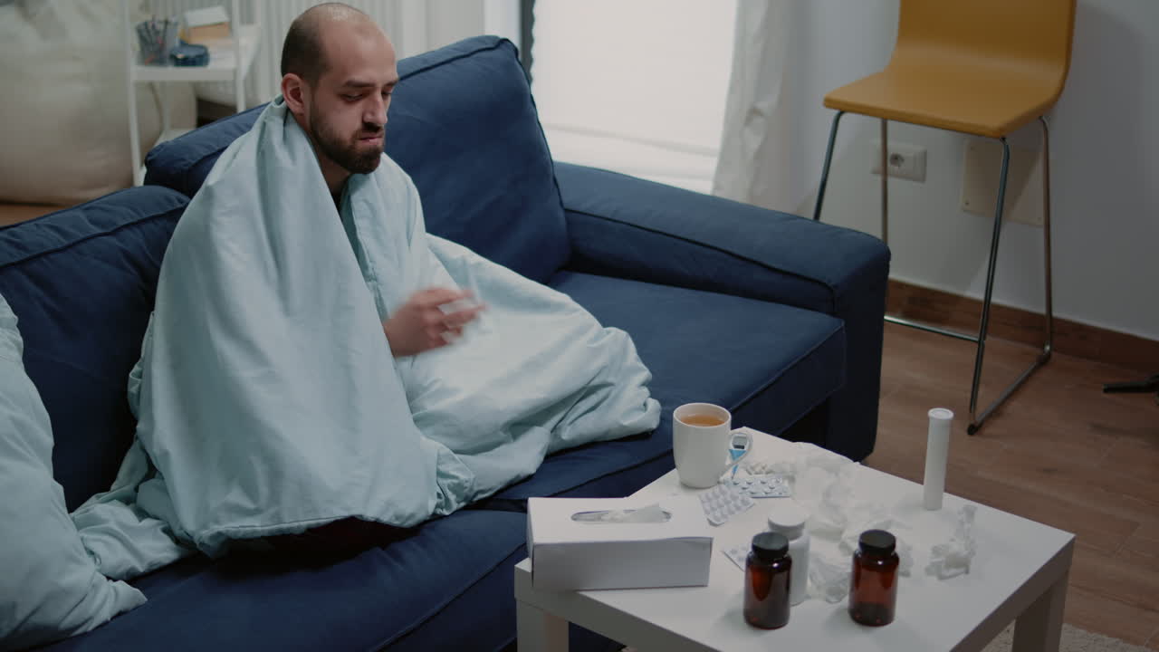 Person with flu blowing runny nose using tissues