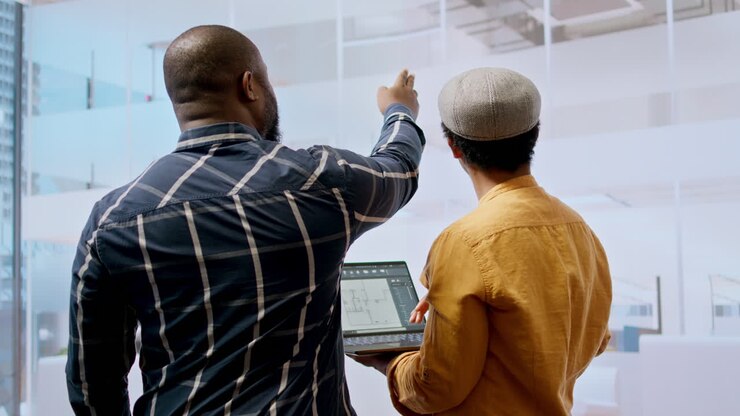 Real estate team and businesswoman discussing workspace design and planning