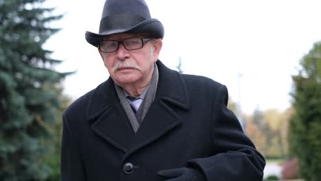 old grandfather’s heart aches, he holds his hand to his chest and writhes in pain. heart problems