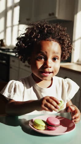 happy child enjoying macarons