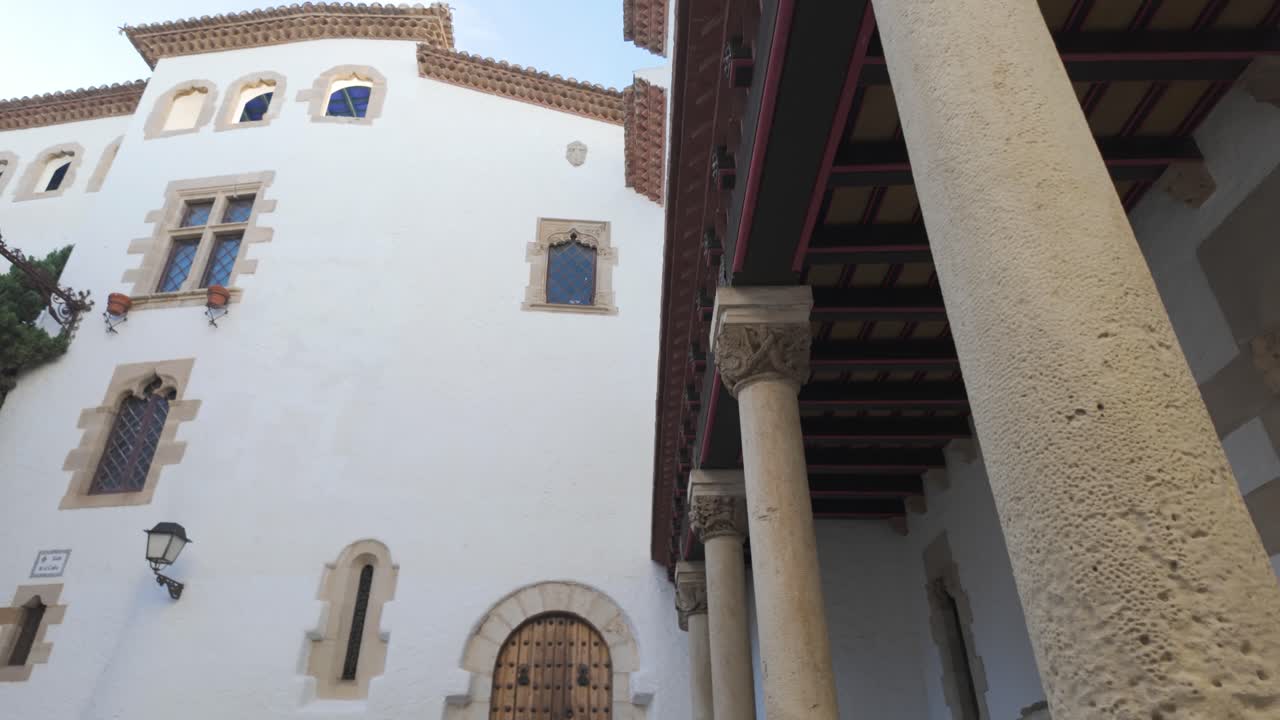 An ornate facade with stone columns and carved details at Palau de Maricel, Sitges, Spain