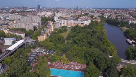 Breathtaking-aerial-top-view-flight-public-swimming-pool-Prinzenbad,-city-Berlin-Germany-Summer-day-2023