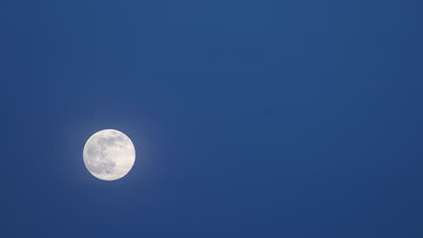 full moon rising in the clear sky at night