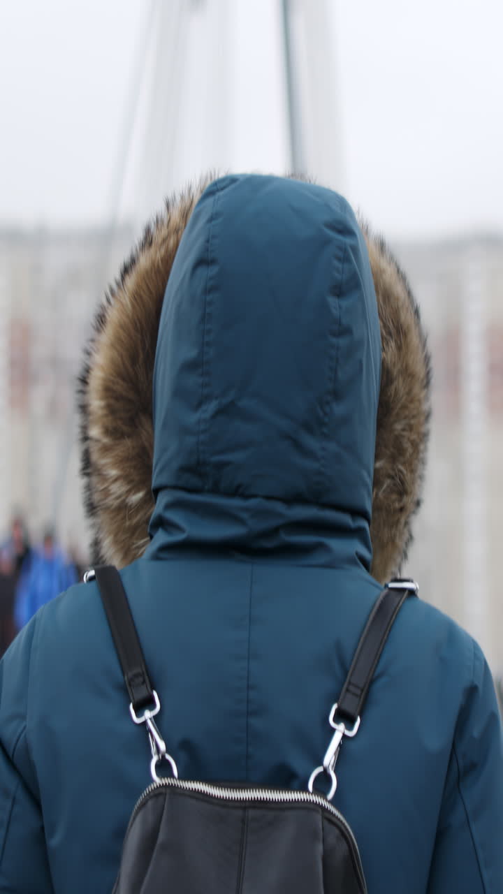 Woman Walking on a Bridge in Winter