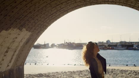 woman standing with hand on hair at dock 4k