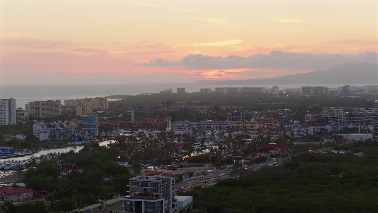 Cityscape at Sunset with Ocean and Mountains