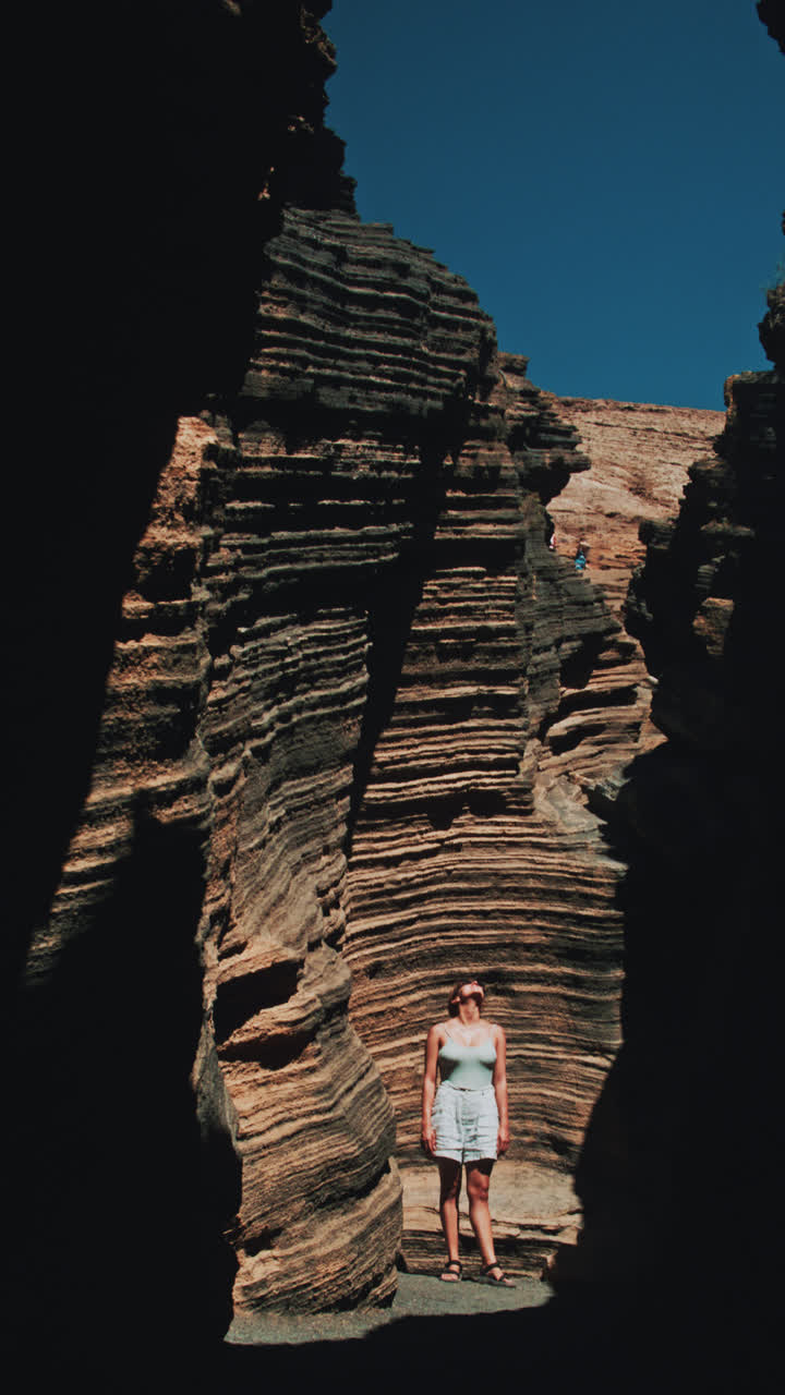 Woman exploring a volcanic canyon