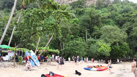 people kayaking and walking on krabi beach