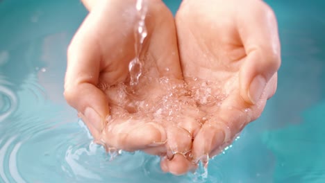 close-up of hands cupping water