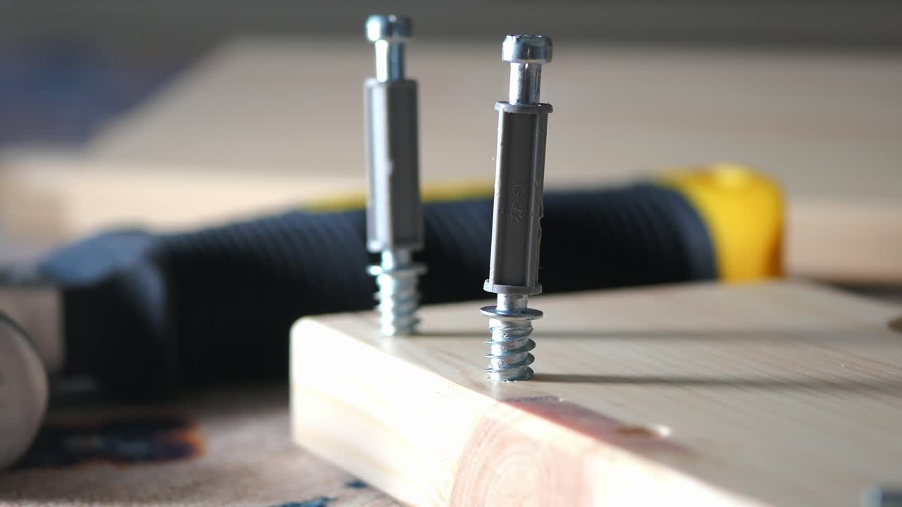Close-up of screws and wood plank for DIY project.