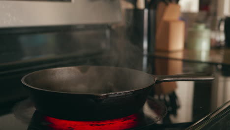 Putting-butter-in-a-hot-cast-iron-skillet-and-it-smokes-as-it-melts