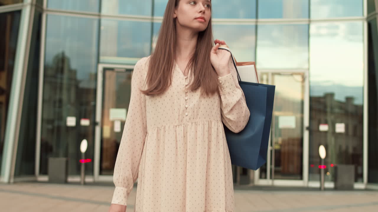 Woman with Shopping Bags Outside Entrance